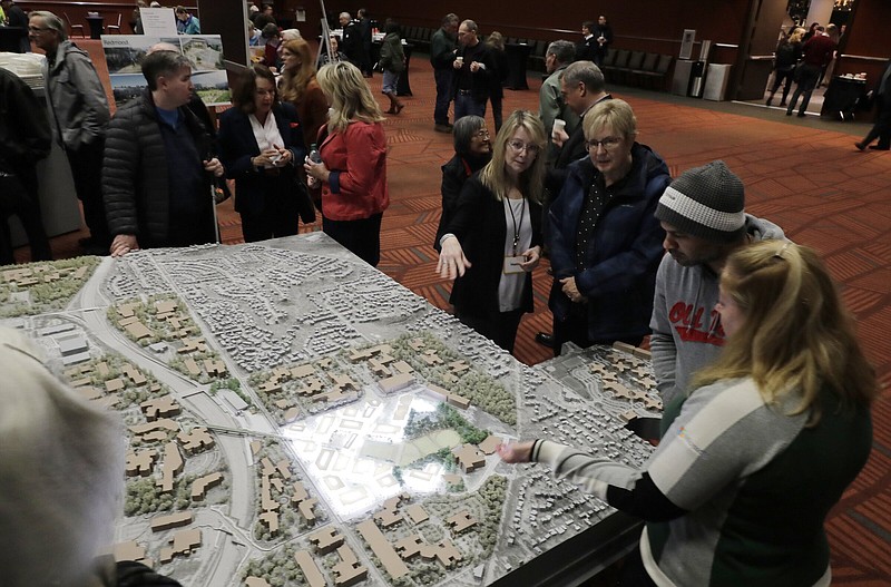 Attendees at the annual Microsoft Corp. shareholders meeting in Bellevue, Wash., look at a display of building and renovation plans for the Microsoft main campus in Redmond, Wash.
(AP)