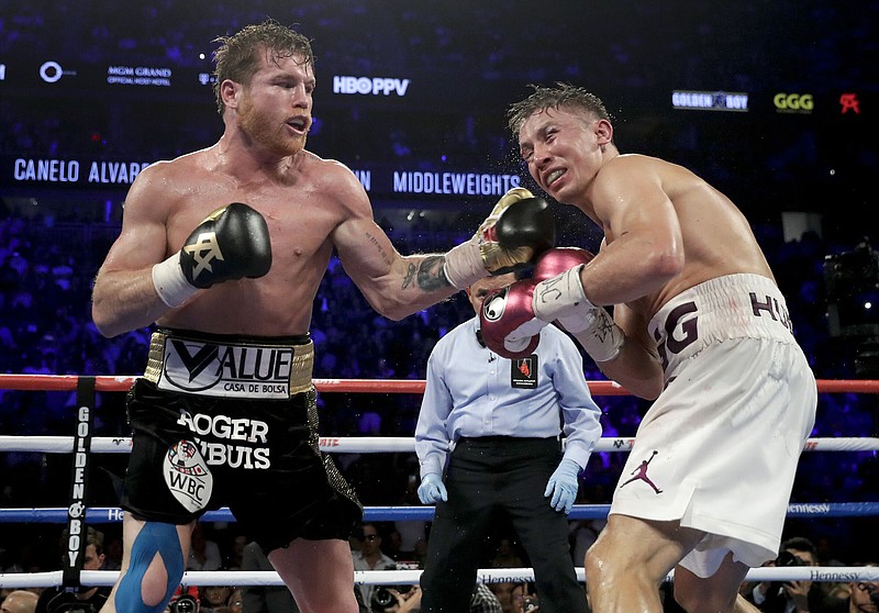 Canelo Alvarez (left) lands a punch during the 12th round of his fight against Gennady Golovkin in September 2018 in Las Vegas. The two are scheduled to fight for a third time on Sept. 17 and Alvarez guaranteed at a news conference Friday promoting the bout that he will “definitely” punch Golovkin into retirement with a knockout.
(AP file photo)