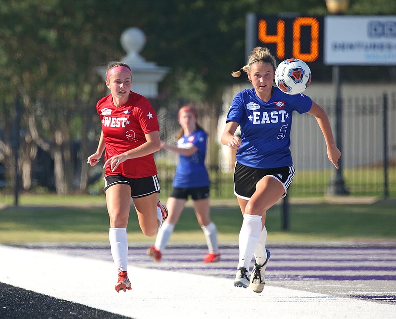 The West’s Lynley Bowen (left) of Farmington and the East’s Meghan Murphy of Little Rock Christian chase a loose ball during the Arkansas High School Coaches Association All-Star girls soccer game on Friday in Conway. The West won 4-0. See more photos at arkansasonline.com/625girlssoccer/
(Arkansas Democrat-Gazette/Colin Murphey)