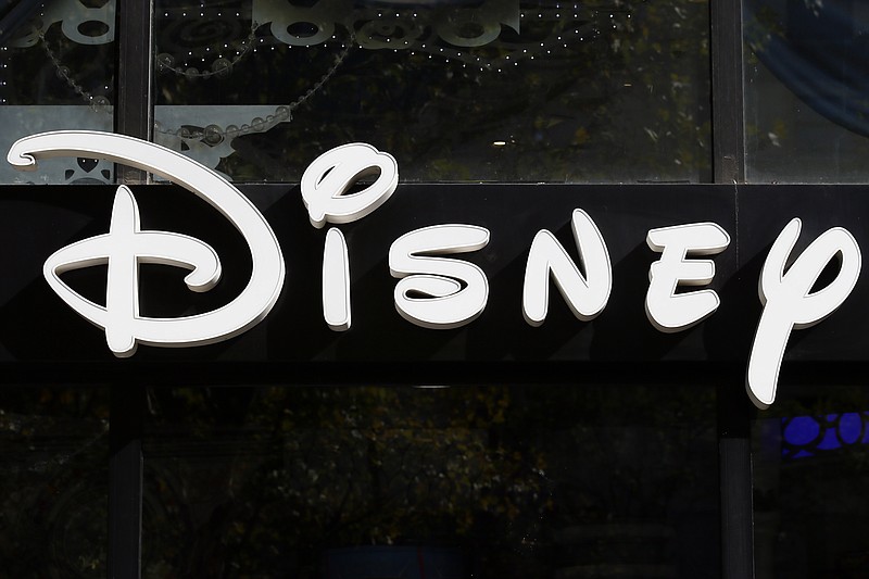 FILE - This Sept. 20, 2017, file photo shows a sign at the Disney store on the Champs Elysees Avenue in Paris, France.  The Supreme Courtâ€™s decision to end the nationâ€™s constitutional protections for abortion has catapulted businesses of all types into the most divisive corner of politics. A rash of iconic names including The Walt Disney Company, Facebook parent Meta, and Goldman Sachs announced they would pay for travel expenses for those who want the procedure but can't get it in the states they live in.  (AP Photo/Francois Mori, File)