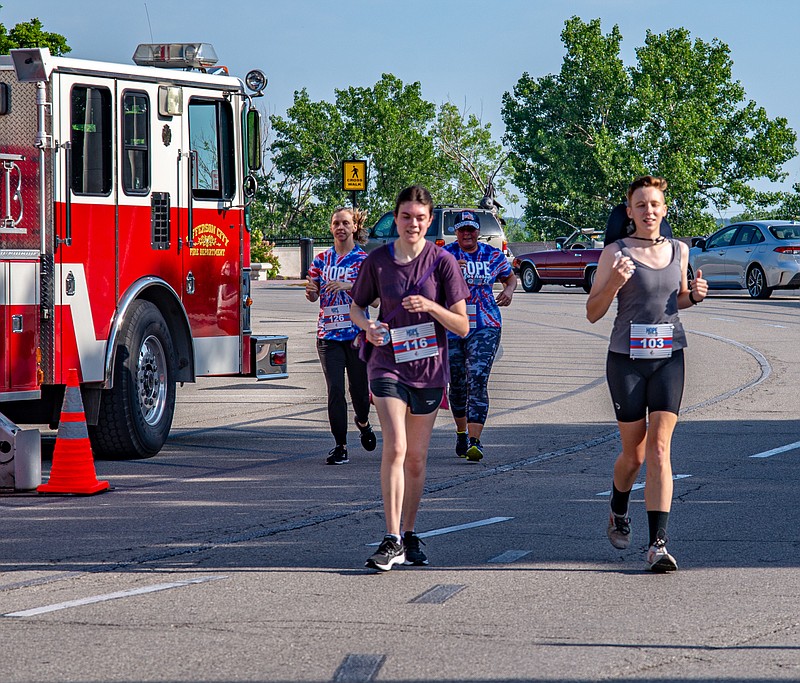 Runners finish the Hope for Heroes 5K Saturday morning to raise money for the Food Bank for Central and Northeast Missouri.  (Ken Barnes/News Tribune)