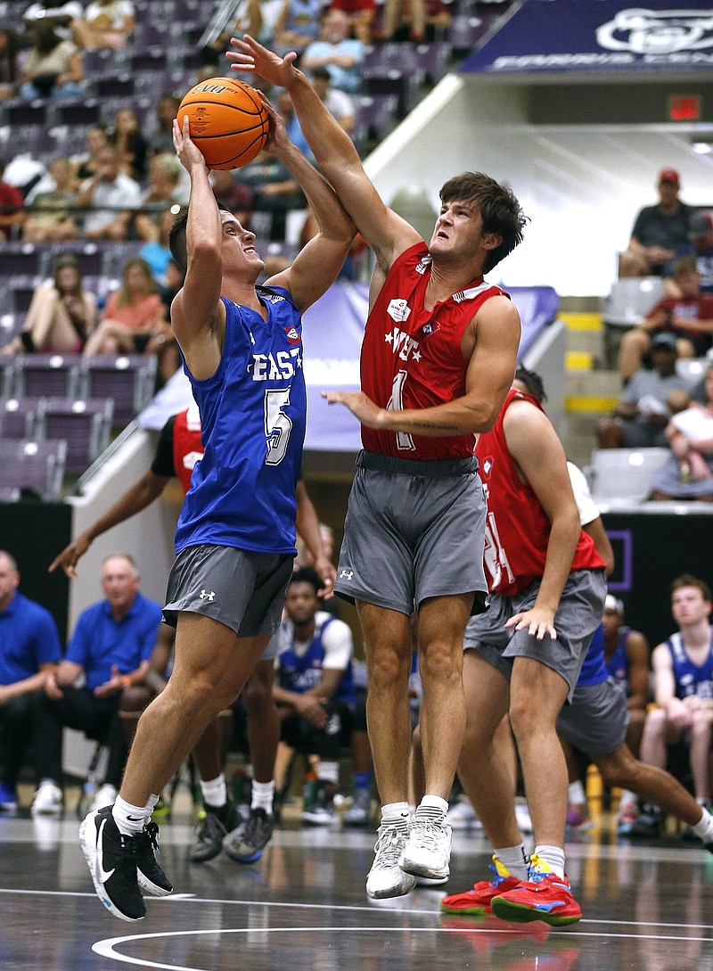 West All Star Cash Oliver (1) guards East All Star Gabe George (5) as he puts up a shot during the High School Coaches Association All-Star Game on Saturday, June 25, 2022, at the Farris Center in Conway. .More photos at www.arkansasonline.com/626boysbb/.(Arkansas Democrat-Gazette/Thomas Metthe)