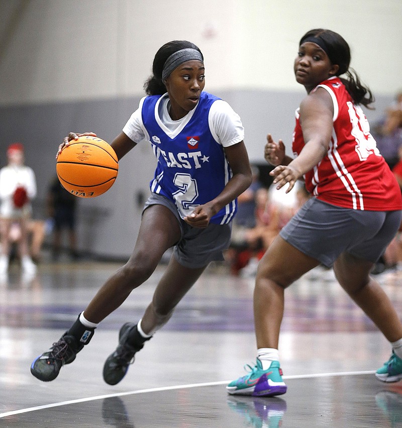 East All Star Parris Atkins (2) drives to the basket while guarded by West All Star Madeleine Tipton (24) during the High School Coaches Association All-Star Game on Saturday, June 25, 2022, at the Farris Center in Conway. .More photos at www.arkansasonline.com/626girlsbb/.(Arkansas Democrat-Gazette/Thomas Metthe)