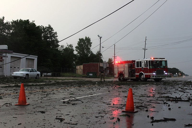 A fire truck blocks a portion of U.S. Highway 67, just east of East Street, after utility lines fell across the roadway during a strong storm that moved the area Sunday, June 26, 2022, in Texarkana, Ark. (Staff photo)