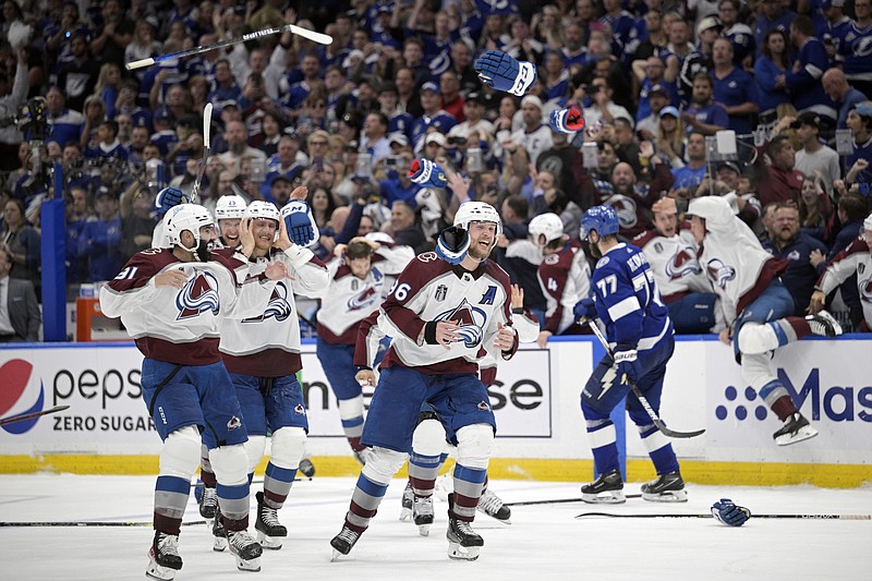 Gloves and sticks are tossed as the Colorado Avalanche celebrate winning the Stanley Cup against the Tampa Bay Lightning in Game 6 of the NHL Stanley Cup Finals on Sunday in Tampa, Fla. - Photo by Phelan Ebenhack of The Associated Press