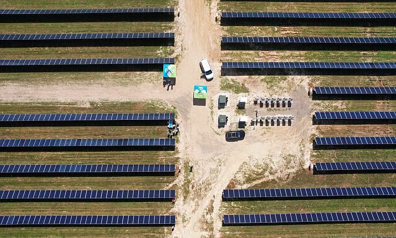 A group of people gather in the middle of the Central Arkansas Water Cabot Solar Field, as seen in this aerial photo, for a ribbon cutting ceremony Tuesday, June 28, 2022. (Arkansas Democrat-Gazette/Colin Murphey)