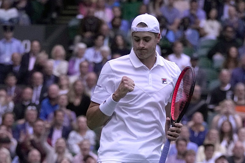 John Isner celebrates winning a point during his second-round match against Andy Murray on Wednesday at Wimbledon in London. Isner defeated Murray 6-4, 7-6 (4), 6-7 (3), 6-4 to advance to the third round.
(AP/Alastair Grant)