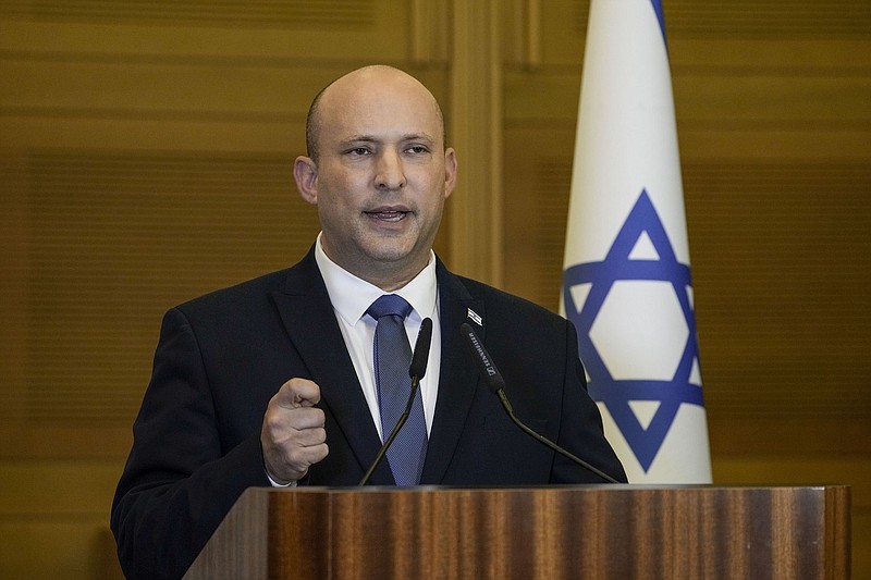 Israeli Prime Minister Naftali Bennett delivers a statement at the Knesset, Israel's parliament, in Jerusalem, Wednesday, June 29, 2022. Bennett will not run in upcoming elections, after he led a broad but fragile coalition government that came unraveled barely a year after taking office. 
(AP Photo/Tsafrir Abayov)