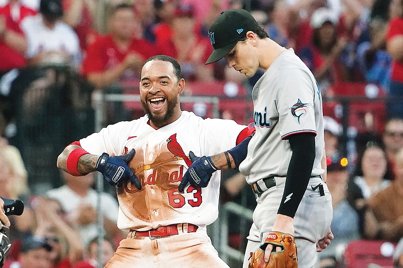 Edmundo Sosa of the Cardinals celebrates along side Marlins third baseman Brian Anderson after hitting a triple during the fifth inning of Wednesday night’s game at Busch Stadium. (Associated Press)