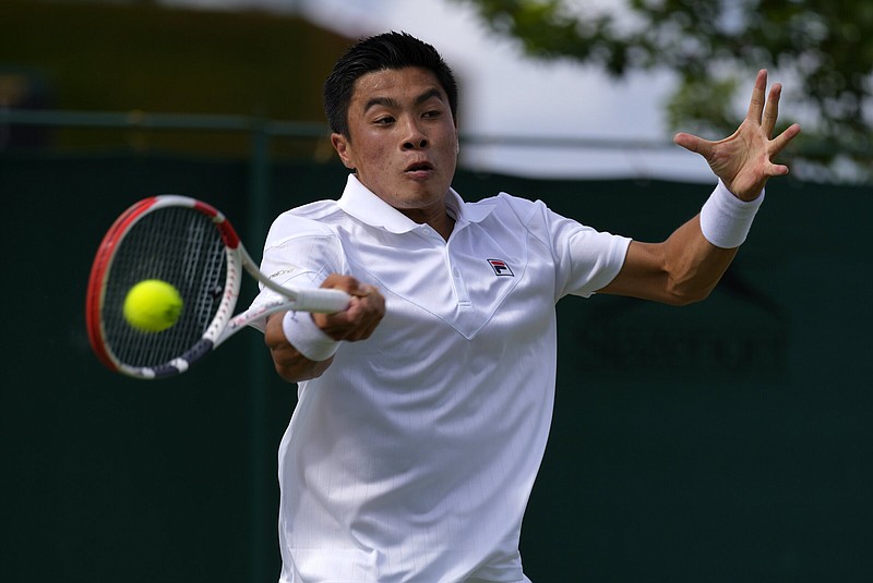 Brandon Nakashima of the United States returns a shot to Canada’s Denis Shapovalov in a second- round Wimbledon men’s single match Thursday in London. Nakashima is one of eight American men to advance to the third round, the most since 1995.
(AP/Alastair Grant)