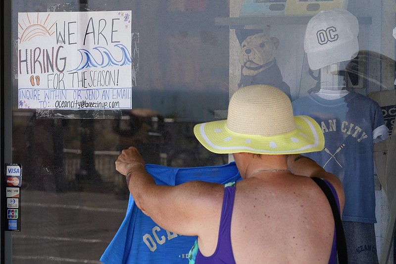 A hiring sign is seen as a person shops for souvenirs along the boardwalk in Ocean City, N.J. in early June.
(AP/Matt Slocum)