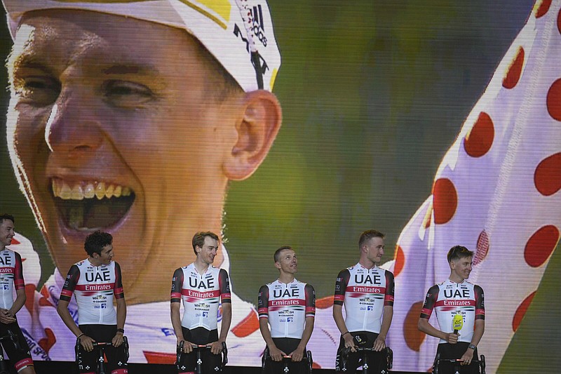 Two-time defending Tour de France winner Tadej Pogacar of Slovenia (right and on screen wearing the best climber’s dotted jersey) lines up with UAE Team Emirates riders during Wednesday’s team presentation before the Tour de France in Copenhagen, Denmark. The race starts today with an individual time trial over 8.2 miles that begins and ends in Copenhagen.
(AP/Daniel Cole)