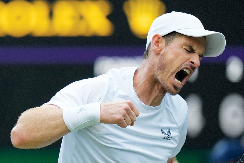 Andy Murray celebrates winning the third set during a men’s singles match Wednesday against John Isner at Wimbledon in London. (Associated Press)