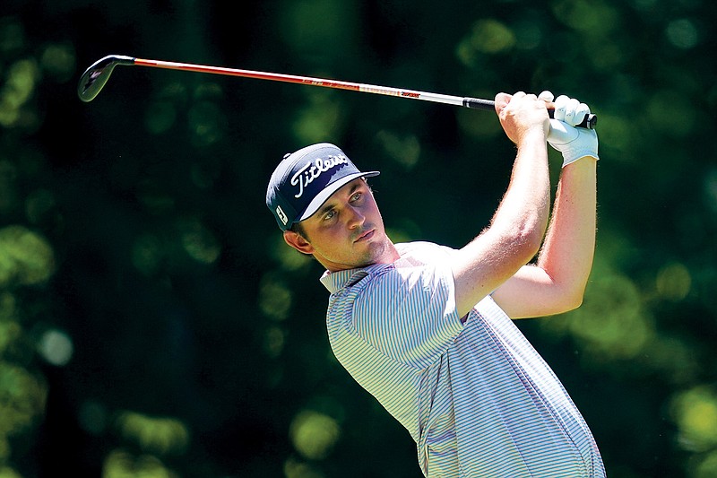 J.T. Poston hits off the sixth tee during Thursday’s first round of the John Deere Classic at TPC Deere Run in Silvis, Ill. (Associated Press)