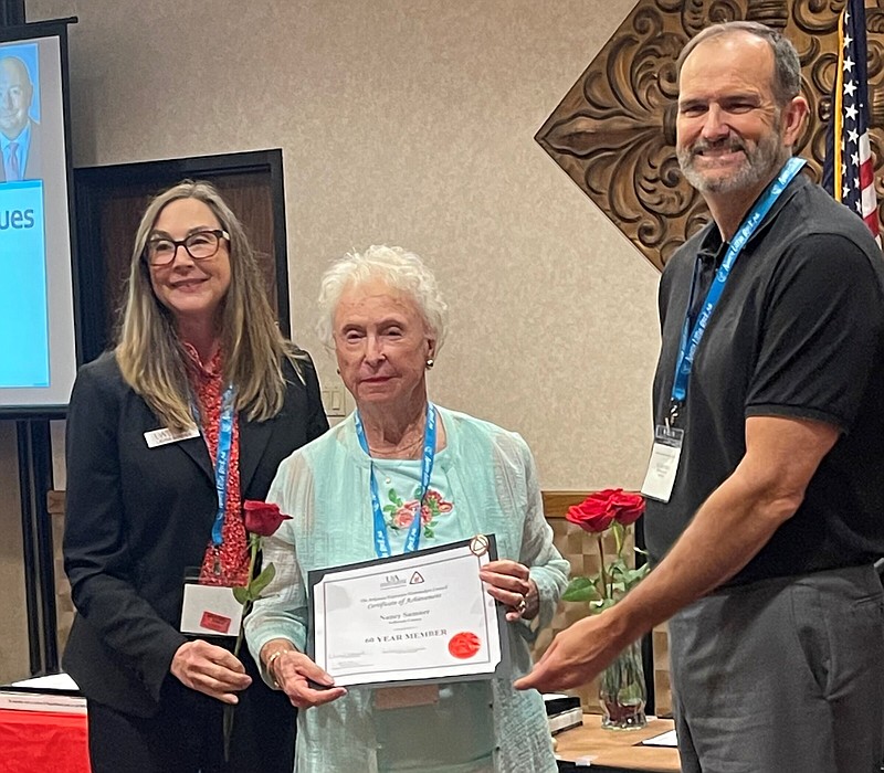 Laura Hendrix (left), Arkansas Extension Homemakers Council adviser, presents Nancy Sumner with a 60 Year Membership Certificate along with Bob Scott, senior associate vice president for Agriculture-Extension at the Division of Agriculture. 
(Special to The Commercial)
