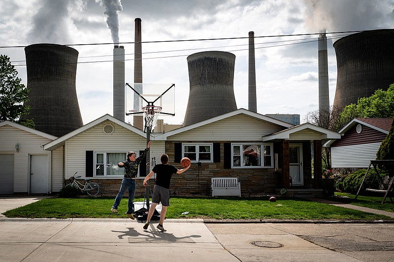 A coal-fired power plant looms over a residential area of Poca, W. Va., on May 6, 2021. Despite the Supreme Court ruling limiting regulatory power over power plants, electric utility companies are already reducing their dependence on coal.
(The New York Times/Erin Schaff)