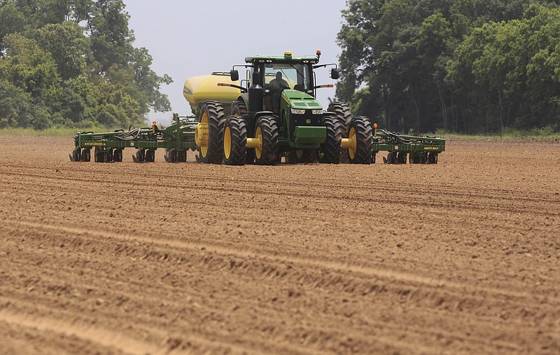 Jose Ramires with Brantley Farms plants soybeans in a field along Arkansas 256 in Jefferson County near the community of Wright in this June 8, 2015 file photo. (Arkansas Democrat-Gazette/Staton Breidenthal)
