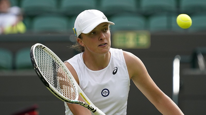 Poland's Iga Swiatek returns to Lesley Pattinama Kerkhove of the Netherlands in a second round women's singles match on day four of the Wimbledon tennis championships in London, Thursday, June 30, 2022. 
(AP Photo/Alberto Pezzali)