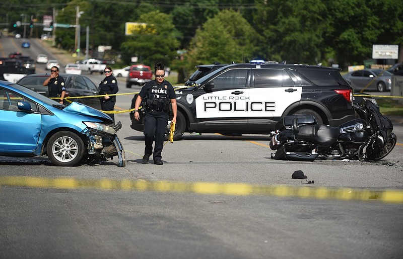 The Little Rock Police Department works the scene of a vehicle-motorcycle accident in the 5300 block of Baseline Road, south Little Rock, on Saturday afternoon, July 2, 2022. (Arkansas Democrat-Gazette/Staci Vandagriff)