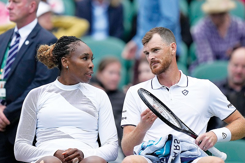 Venus Williams speaks to Jamie Murray during Friday’s mixed doubles match against Alicja Rosolska and Michael Venus at Wimbledon in London. (Associated Press)