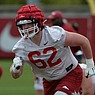 Arkansas offensive lineman Brady Latham takes part in a drill Thursday, April 15, 2021, during practice at the university practice field in Fayetteville.