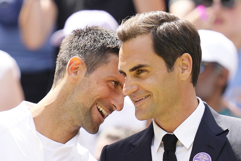 Novak Djokovic and Roger Federer speak during a 100 years of Centre Court celebration Sunday at Wimbledon in London. (Associated Press)