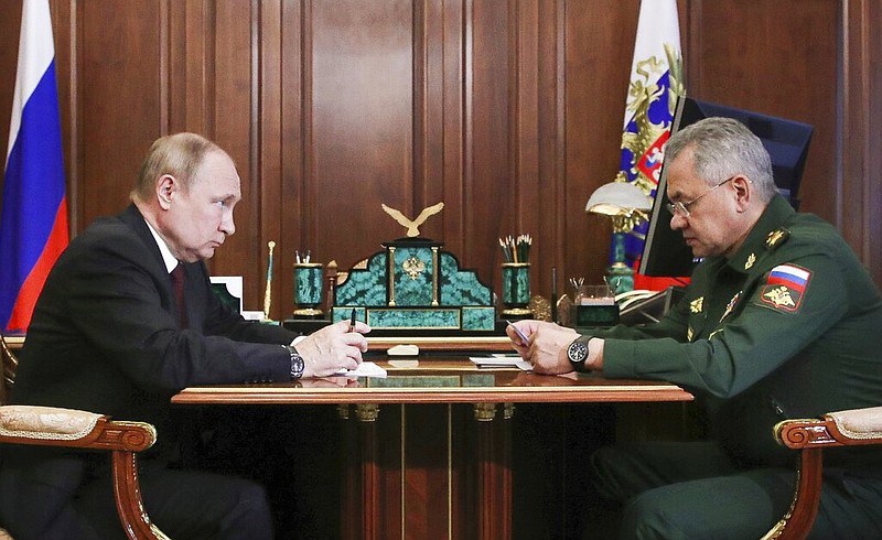 Russian President Vladimir Putin listens to Russian Defense Minister Sergei Shoigu's report during their meeting in the Kremlin in Moscow, Russia, Monday, July 4, 2022. (Mikhail Klimentyev, Sputnik, Kremlin Pool Photo via AP)