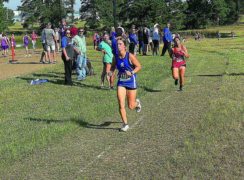 Parkers Chapel's Reaux McAuliffe competes in the El Dorado Wildcat Cross Country Invitational last season at Goodwin Airport Field. The junior will compete in cross country, tennis and golf in the fall and softball and track and field in the spring.