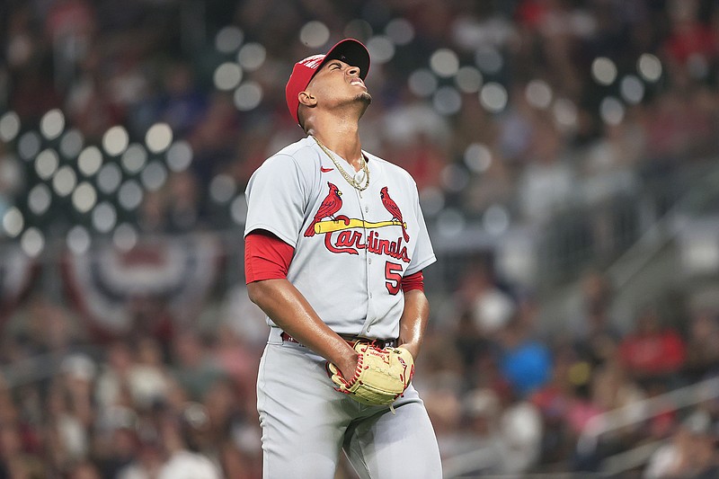 Cardinals relief pitcher Johan Oviedo reacts after being hit by a line drive on his pitching hand in the sixth inning of Monday night's game against the Braves in Atlanta. (The Associated Press)