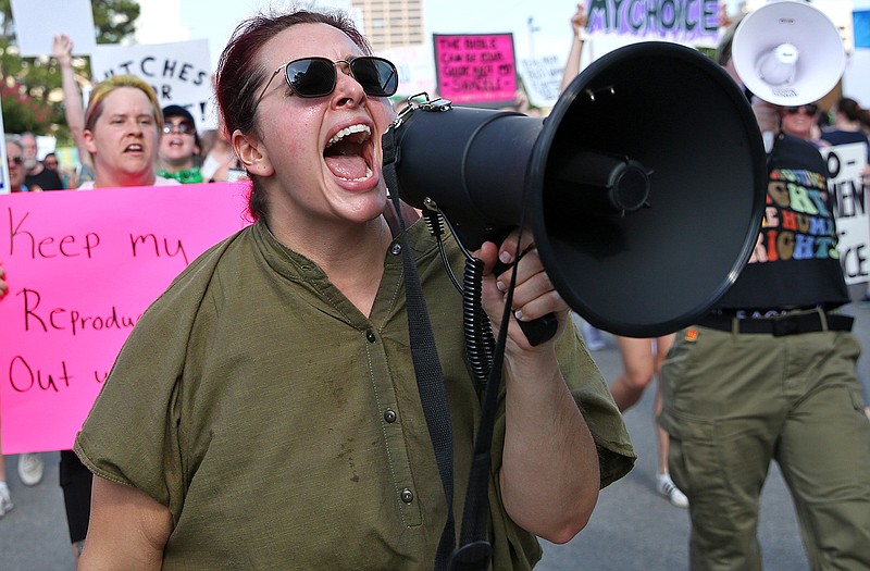Mandee Harden uses a bullhorn to address demonstrators during a reproductive rights march near the Arkansas state Capitol on Monday, July 4, 2022. (Arkansas Democrat-Gazette/Colin Murphey)