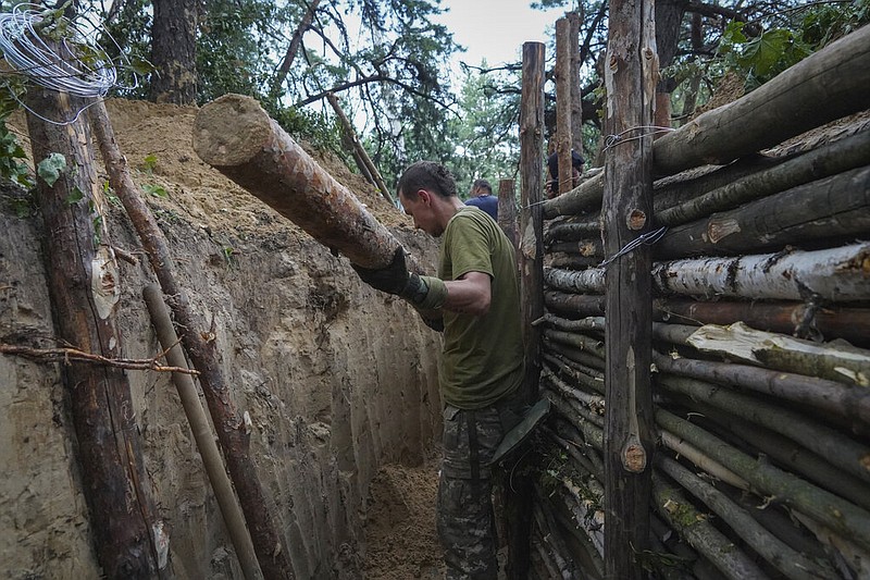 Ukrainian servicemen strengthen trenches on their position near the frontline in Kharkiv region, Ukraine, Tuesday, July, 5, 2022. (AP/Andrii Marienko)