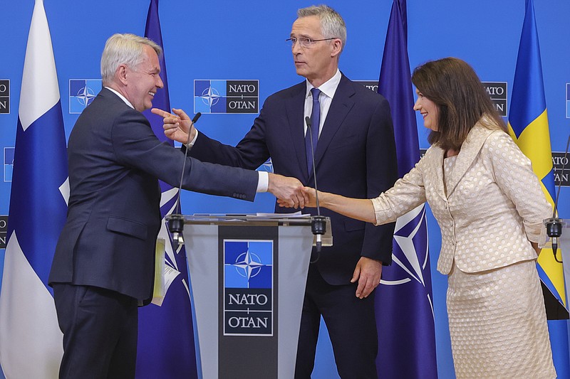 Finland's Foreign Minister Pekka Haavisto, left, Sweden's Foreign Minister Ann Linde, right, and NATO Secretary General Jens Stoltenberg attend a media conference after the signature of the NATO Accession Protocols for Finland and Sweden in the NATO headquarters in Brussels, Tuesday, July 5, 2022. (AP Photo/Olivier Matthys)