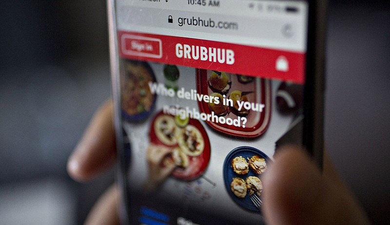 A customer accesses the GrubHub website on an iPhone. Amazon.com has agreed to take a stake in Just Eat Takeaway.com’s food delivery Grubhub business. The service will be offered to Amazon Prime members.
(Bloomberg News WPNS/Andrew Harrer)