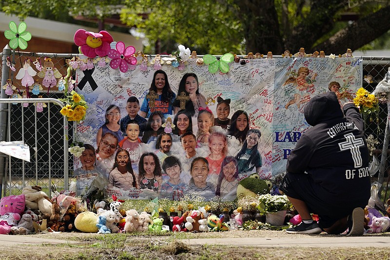 A mourner stops to pay his respects at a memorial at Robb Elementary School, created to honor the victims killed in the recent school shooting, June 9 in Uvalde, Texas.
(AP/Eric Gay)