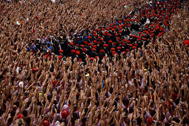 Revelers raise their arms Wednesday as a band plays in the town hall square in Pamplona, Spain, while waiting for the launch of the “Chupinazo” rocket marking the opening of the 2022 San Fermin fiestas, nine days of nonstop partying and running of the bulls. More photos at arkansasonline.com/77spain22/.
(AP/Alvaro Barrientos)