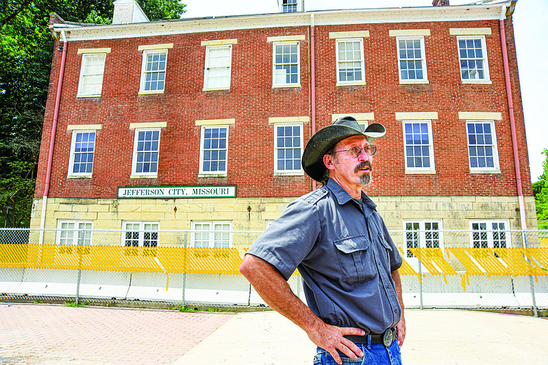 Scott McCullough stands near the Amtrak boarding area just outside the former location of the train station. McCullough, who lives in Columbia, was dropped off to catch the train to Chicago to see his father. The Missouri Legislature this year approved funding for repair of the old Union Hotel at the north end of Jefferson Street. The main level housed the Elizabeth Rozier Gallery while the bottom floor served as the Amtrak station until late 2019 when structural integrity issues forced the building to be closed to the public. (Julie Smith/News Tribune photo)