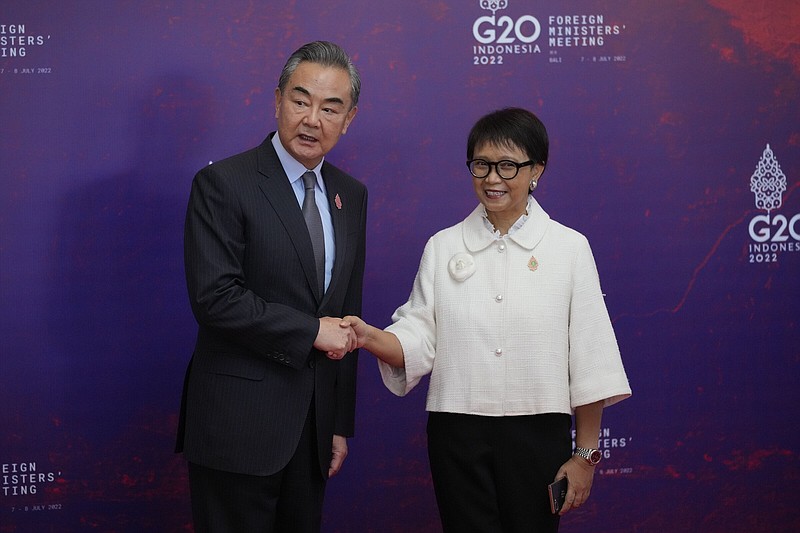 Indonesian Foreign Minister Retno Marsudi (right) greets Chinese Foreign Minister Wang Yi upon arrival on Friday at the G-20 Foreign Ministers’ Meeting in Nusa Dua, Indonesia.
(AP/Dita Alangkara)