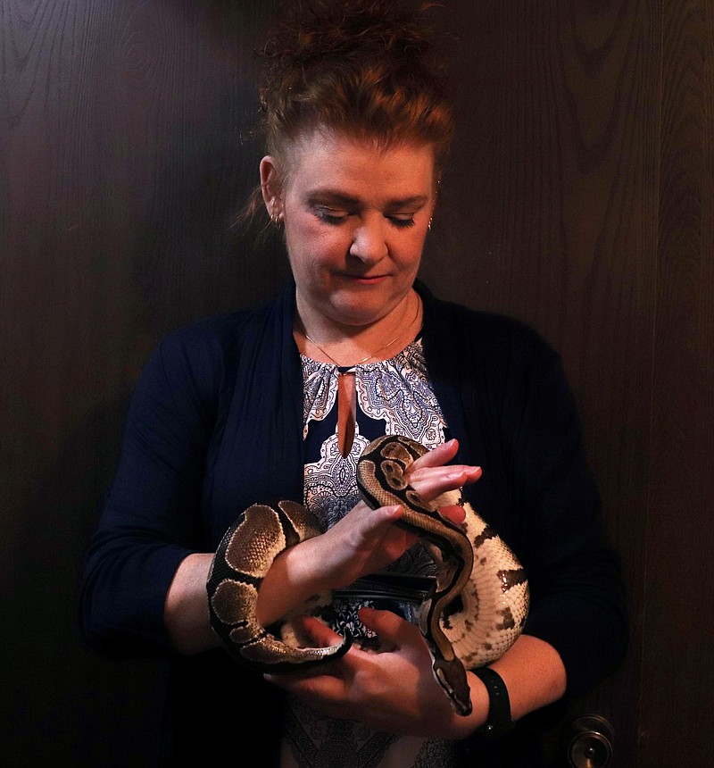 Mindy Craig holds one of her pythons.