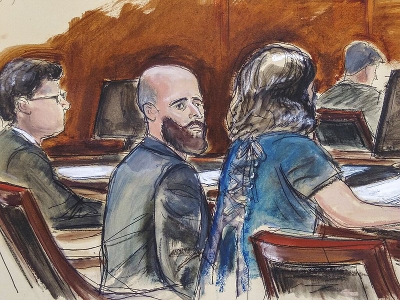 In this courtroom sketch dated March 4, 2020, Joshua Schulte (center) is seated at the defense table flanked by his attorneys during jury deliberations in New York. Schulte is a former CIA software engineer accused of causing the biggest theft of classified information in CIA history. (Elizabeth Williams via AP)