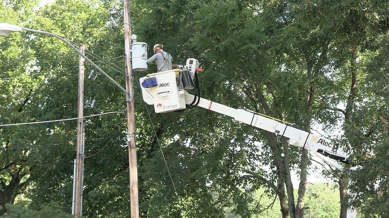 An Entergy crew works Wednesday morning on power restoration in the 2700 block of Malvern Road following severe weather the night before. - Photo by Lance Porter of The Sentinel-Record