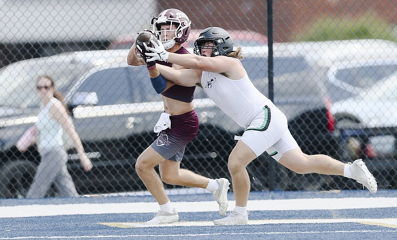 Van Buren linebacker Grant King (right) breaks up a pass Thursday during the Southwest Elite 7-on-7 Tournament in Springdale.
(NWA Democrat-Gazette/Charlie Kaijo)