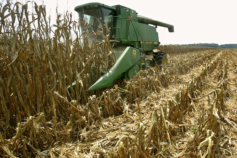 Keith Feather uses a combine to farm his corn field in Griffithville after a summer with a long drought in this August 2005 file photo. (Arkansas Democrat-Gazette file photo)