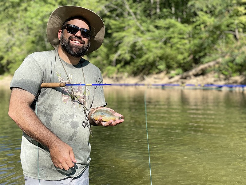 After helping Mount Eagle Fishing Retreat participants to access hard-to-reach spots on the Little Red River, Clint Johnson got out his own pole and started reeling in fish, including this longear sunfish. A self-described “fishing facilitator,” Johnson donated his time to make last weekend’s event a success.
(Arkansas Democrat-Gazette/Frank E. Lockwood)