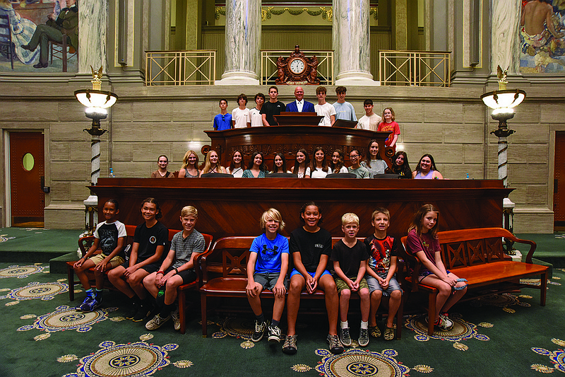 Students from Spain, 17 in total, and host families visited the Missouri Capitol Thursday, July 14, 2022, for a tour and a brief meeting with state Sen. Mike Bernskoetter in the well of the Missouri Senate, including discussion about how bills are passed, formalities and etiquette while in session. (Julie Smith/News Tribune photo)
