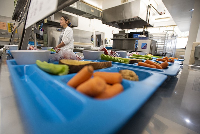 Medina Amor, a food server, prepares lunch trays at Fairview Elementary School in Fort Smith as part of the Fort Smith School District's 2022 Summer Meals Program in this June 2, 2022 file photo. (NWA Democrat-Gazette/Hank Layton)