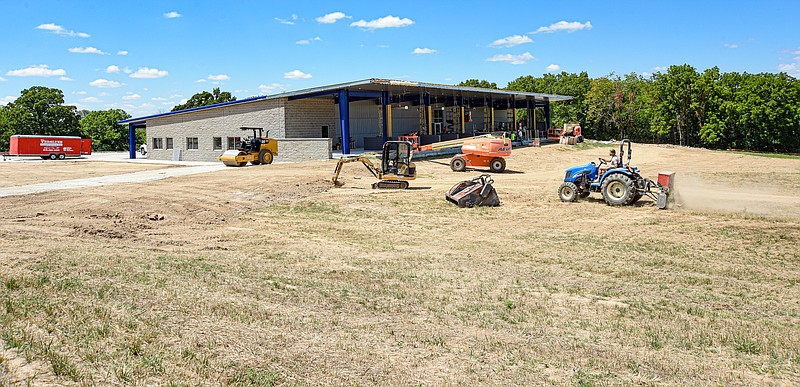 As contractors continue their work at the new driving range at Linn Country Club, Dylan Light, in foreground, operates a tractor to work the soil on July 13, 2022, for the area that will host the greens. State Technical College of Missouri purchased the former Linn Country Club where work is underway to construct a multi-level clubhouse that will feature amenities for students at State Tech. Light is a student in the Commercial Turf and Grounds Maintenance course. (Julie Smith/News Tribune photo)
