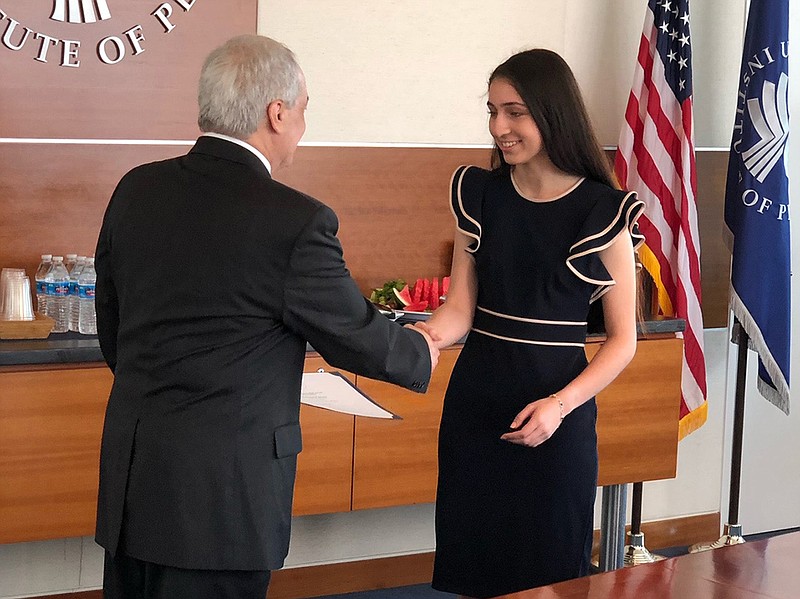 Pulaski Academy student Mariam Parray shakes hands Wednesday with Michael Yaffe, vice president of the Middle East North Africa Center at the U.S. Institute of Peace in Washington. Parray says she wants to pursue an international relations degree.
(Photo courtesy of Bill Topich)