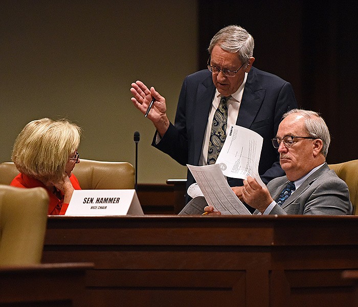 Rep. Jack Ladyman (center) talks with Sen. Cecile Bledsoe (left) and Sen. Kim Hammer during a recess of the Executive Subcommittee of the Arkansas Legislative Council meeting Wednesday at the State Capitol.
(Arkansas Democrat-Gazette/Staci Vandagriff)