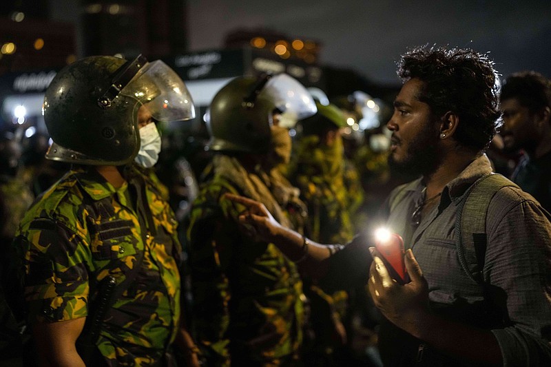 A protester tries to speak with an army officer at the site of a protest camp outside the Presidential Secretariat in Colombo, Sri Lanka, early today.
(AP/Rafiq Maqbool)