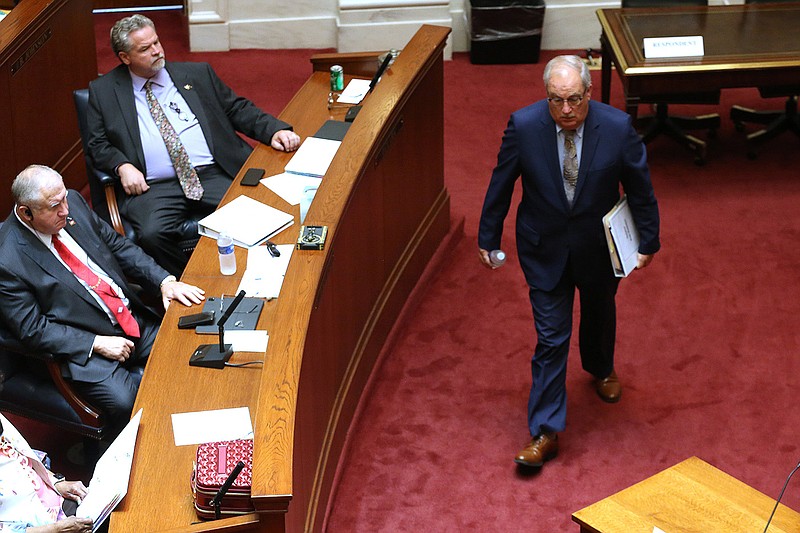 Ethics Committee chairman Kim Hammer (right) makes his way to discuss ethics committee findings about Sen. Alan Clark (top left) and Sen. Mark Johnson on Thursday at the state Capitol in Little Rock.
(Arkansas Democrat-Gazette/Thomas Metthe)